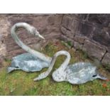 A pair of bronze swans with Verdigris finish, 70cm long max x 65cm high max