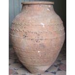 A large terracotta storage jar with simple repeating incised detail, 73 cm in height