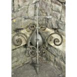 A substantial iron work two branch wall mounted candelabra with scrolled detail, 85 cm in height