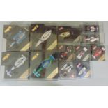Collection of 12 Formula One model racing cars in display cases, including 4 1:24 scale Onyx