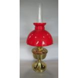 Aladdin brass oil lamp with red shade and flue, 60cm high total