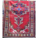 Persian runner with central medallion upon a red ground, 210 x 120 cm