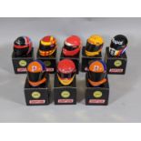 Collection of 8 boxed model motor racing helmets by Simpson