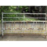 A galvanised steel plant stand with four simple ring pot receptacles and tubular framework, 107 cm