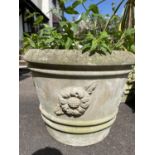Three matching reclaimed planters of circular tapered form with ribbed and repeating flower head