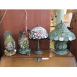 A Tiffany style table lamp with globular shaped body together with four others of varying design,