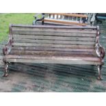 Late 19th century garden bench with decorative iron ends and timber lathes