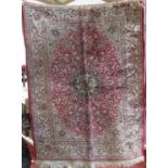 Modern Kashmir type rug with floral cream medallions upon a red ground, 140 x 100 cm