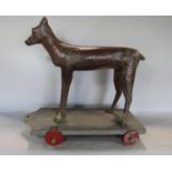 Good quality 19th century folk art carving of a standing hound upon a plinth base with wheels,