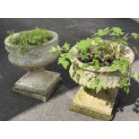 A pair of reclaimed garden urns the squat circular and lobbed bowls with repeating flower head