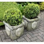 A pair of reclaimed square planters with simulated rough hewn finish and raised relief repeating