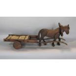 Folk art carving of a horse pulling a cart, 70cm long