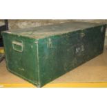 A green painted steel trunk containing various power tools comprising a Black and Decker KA510