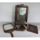 Two naive oak hand mirrors, one of typical form, the other with hinged shutter; together with a