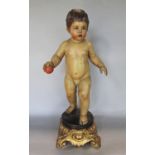Good quality probably Italian carved softwood figure of a nude boy holding a ball upon a black