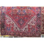 Good quality full pile Hamadan village type carpet with block Islamic panels upon a red ground,