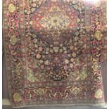 A good quality Persian rug with central floral medallion and further floral sprays upon a deep