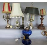 A collection of six good table lamps comprising a three light example with tolware shade and brass