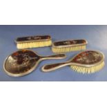 Silver and tortoiseshell piquet work four piece dressing set comprising three brushes and a