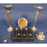 A mixed collection of silver comprising a pair of faceted flared vase, capstan inkwell, cased set of