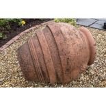 A weathered contemporary olive jar with banded and raised flower head detail, 72 cm high