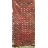 Antique Bokhara rug with small geometric medallion decoration upon a deep red ground, 200 x 140