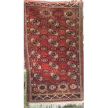 A good quality double handstitched Bokhara rug with typical geometric decoration upon a washed red/