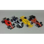 4 unboxed Formula 1 model racing cars 1:24 scale by Burago including Brabham BT52, Lotus 97T,