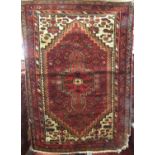 Persian rug with central red medallion upon a brick red ground, 150 x 105 cm (AF)
