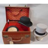 Leather travelling case fitted for carrying top hat and accessories, containing black silk top