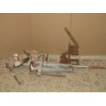 A vintage heavy cast iron bench vice, a further leg vice and a cast iron lever operated press,