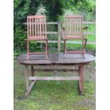 A weathered teak D end pull out extending garden table with two stowaway bi fold leaves together