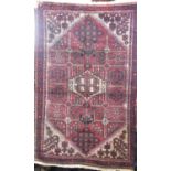 Good quality Persian full pile rug with medallion decoration and floral reserves upon a maroon