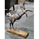 An attractive clay pottery sculpture of a rearing horse/stallion raised on a contemporary light