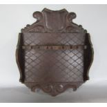 19th century oak spoon rack with shield and acanthus pediment and carved diaper back board, 40cm