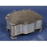 Early 20th century silver ring box/pin cushion, the hinged top over serpentine body and fancy