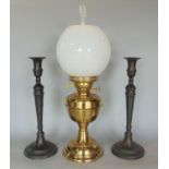 Brass duplex oil lamp with glass shade and flue, 54 cm high in total, together with a pair of iron