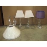 A pair of contemporary moulded glass table lamps with tapered faceted form, one other and a pair