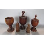 A collection of antique fruitwood cup and covers, together with a further pair of treen salt and