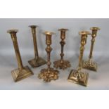 Three pairs of bell metal candlesticks to include a petal base, a Corinthian column and further