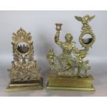 Two cast brass pocket watch holders, one in the form of a maiden holding a candlestick sconce with a