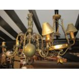 An ironwork hanging ceiling light with gilt finish, the circular ring supporting three branches/