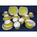 A collection of Shelley china teawares with floral border decoration above a yellow ground