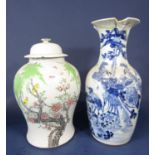 A 19th century oriental blue and white baluster shaped vase with painted bird and flowering tree