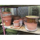 A quantity of reclaimed terracotta flower pots of varying size and design together with a further