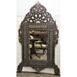 A late 19th century Moorish wall mirror with honeycomb pierced detail and repeating foliate