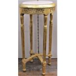 A circular jardinière stand with gilded finish, inset marble top and fluted support, 78cm high