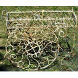 A novelty weathered painted wirework planter in the form of a cart, with two moveable wheels and