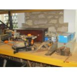 An Evolution electric multi purpose sliding mitre saw together with a box of miscellaneous tools,