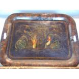 A Victorian twin handled jappaned tin tray, decorated with two female figures in a garden